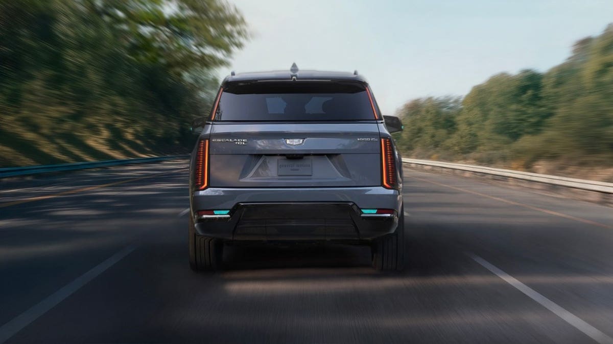 General Motors' Cadillac Escalade IQ drives down a road.