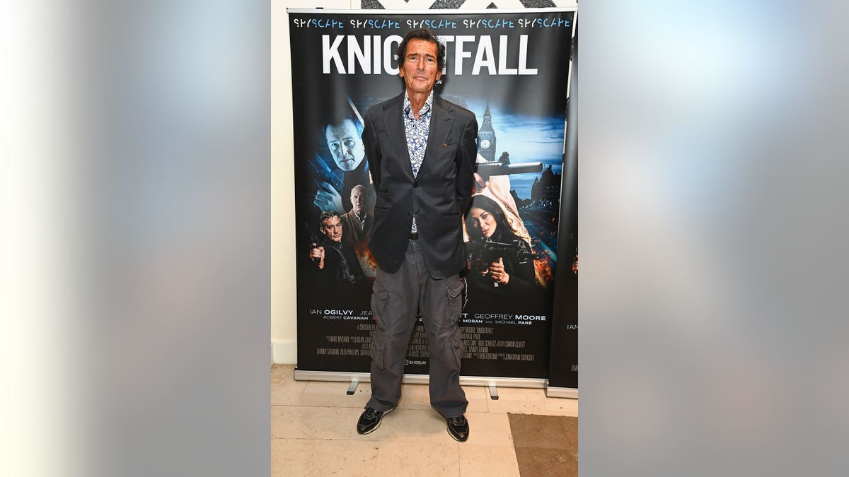 Geoffrey Moore stands on the red carpet at the London premiere of Knightfall.