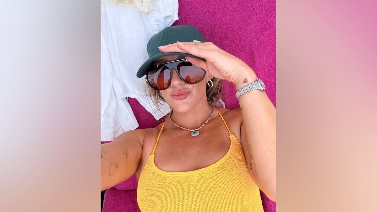 Hilary Duff poses for a selfie on a towel.