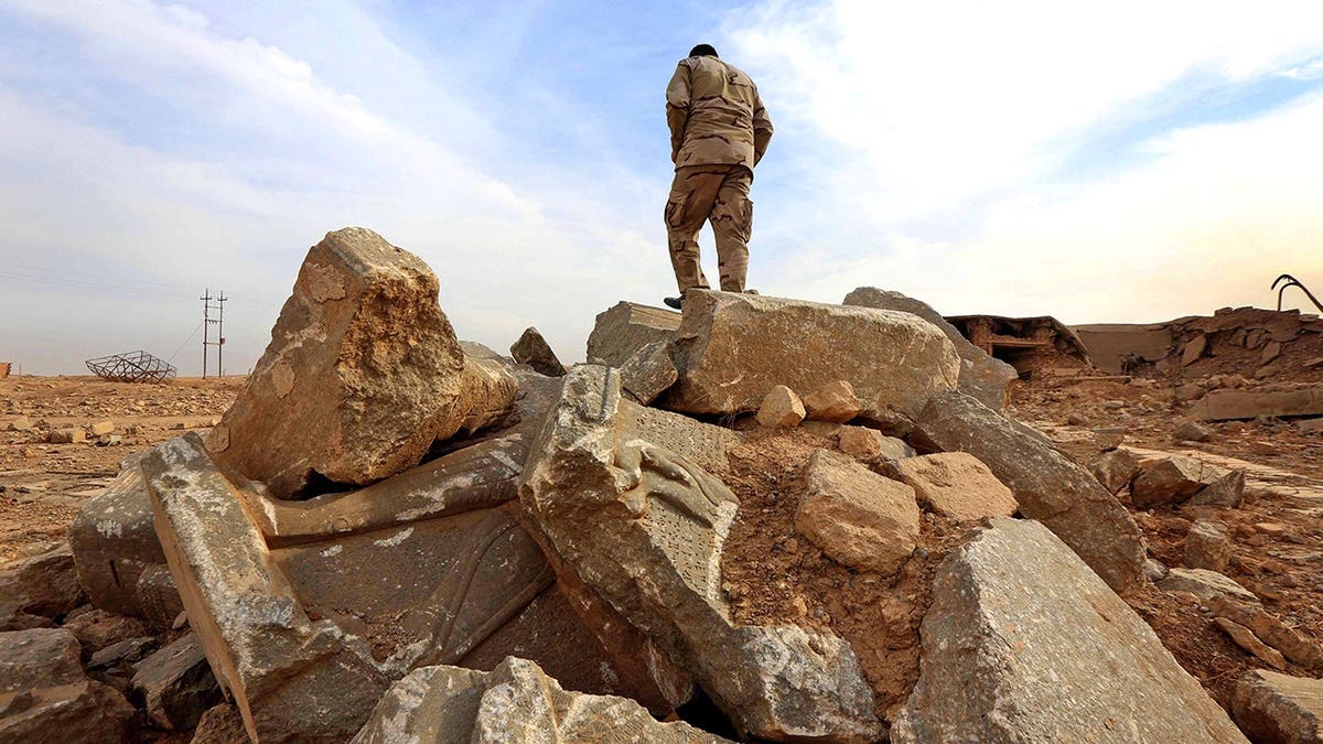 Man standing in wake of ISIS destruction in Syria