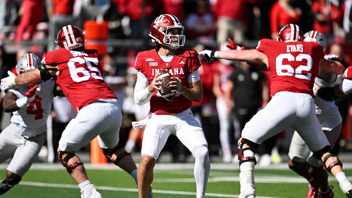 Josh Hoover standing on the field during a college football game