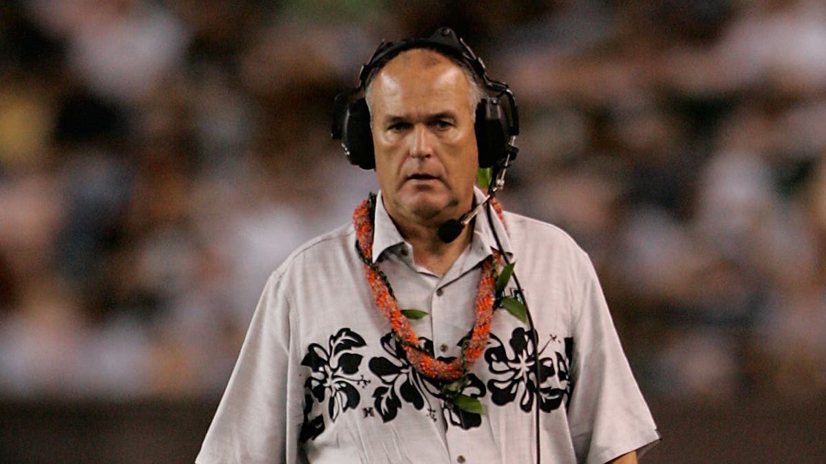 June Jones walks the sidelines during a college football game at Aloha Stadium.