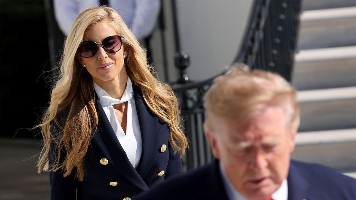 Katie Zacharia behind Donald Trump
