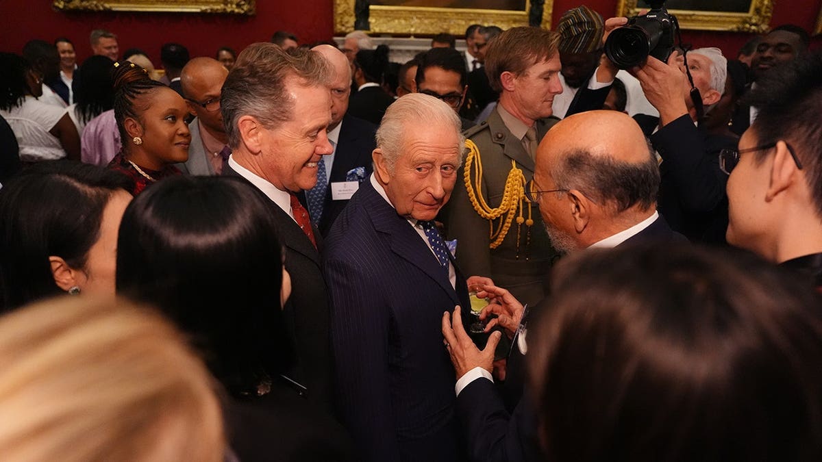 King Charles III meets guests at a reception in St. James's Palace, London.