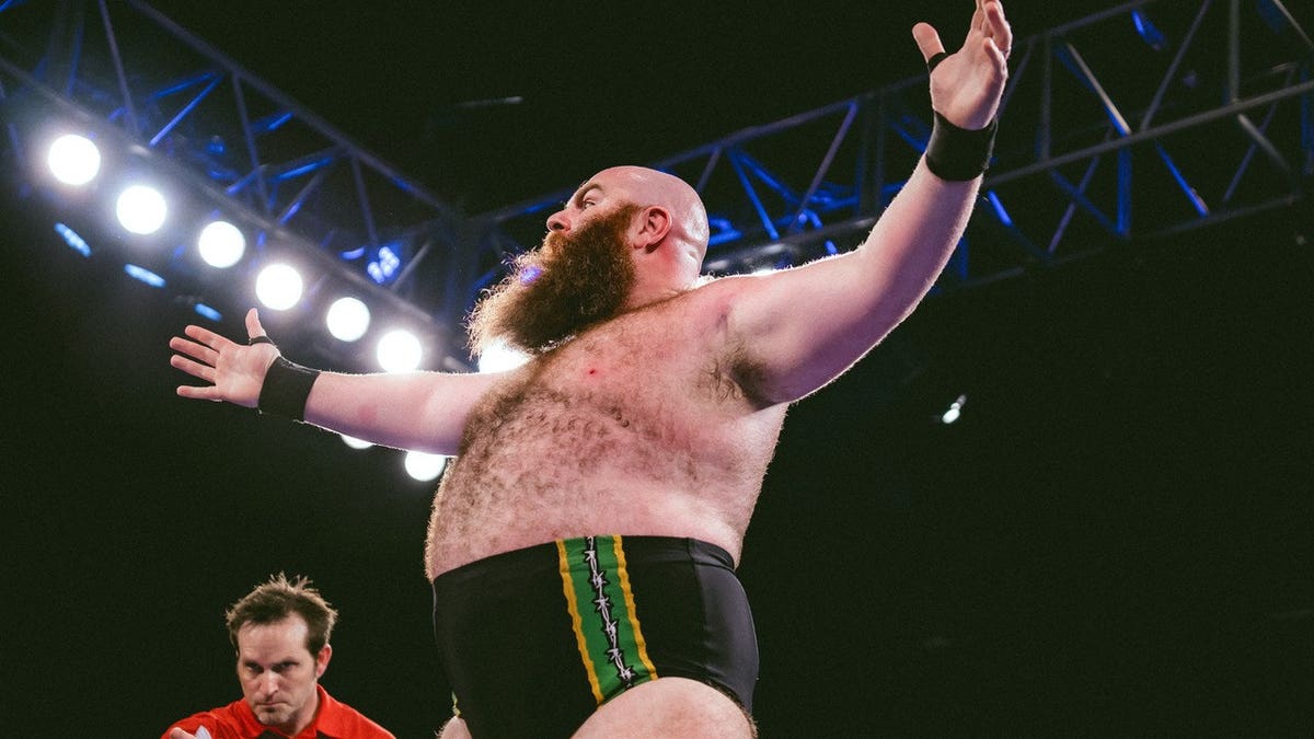 Big Damo lifts up his arms