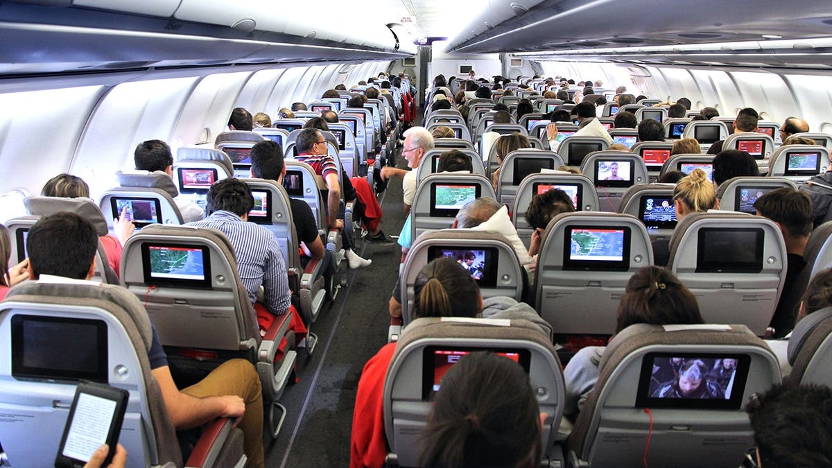 View of large airplane cabin with passengers