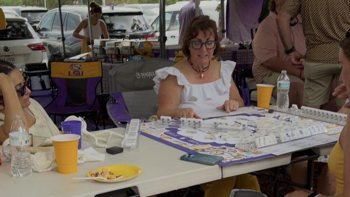 Tailgaters play Mahjong outside Tiger Stadium on the campus Louisiana State University