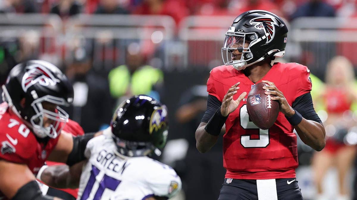 Michael Penix Jr. looks to pass against the Baltimore Ravens at Mercedes-Benz Stadium