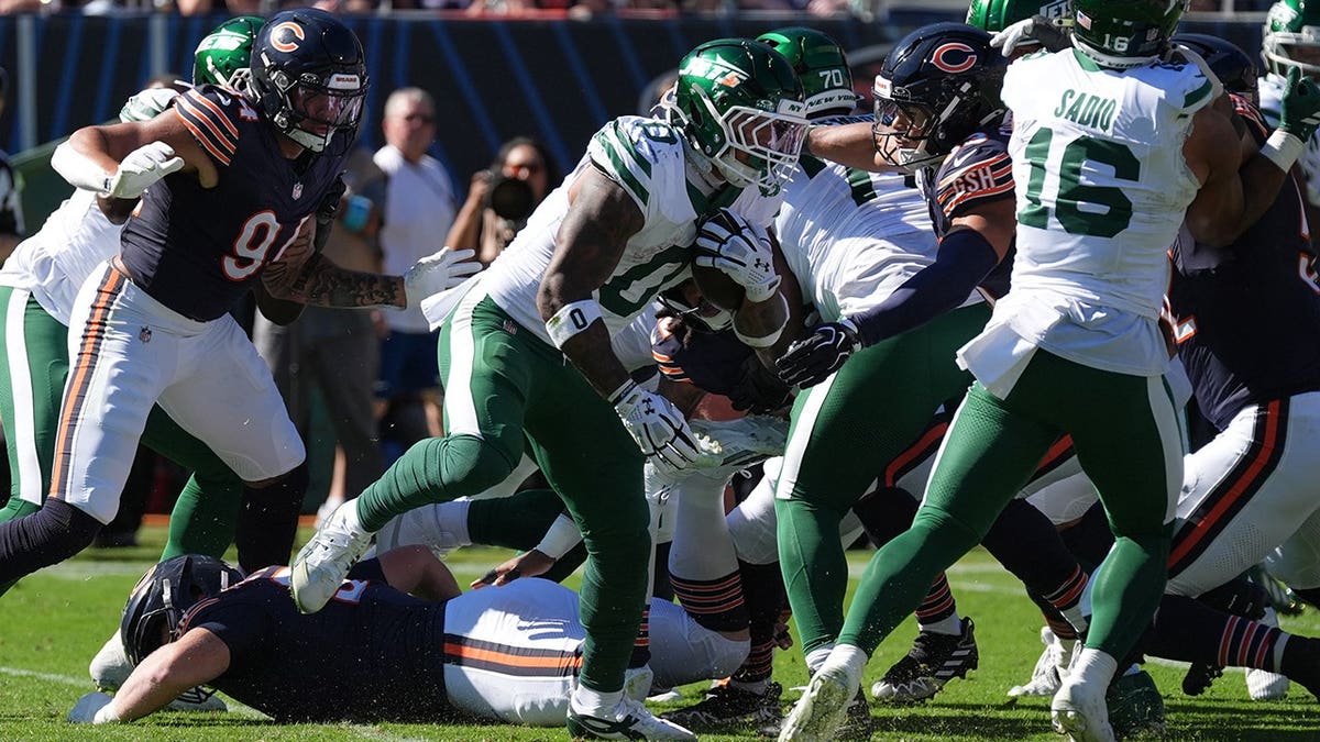 Braelon Allen runs with the ball during an NFL game against the Chicago Bears.