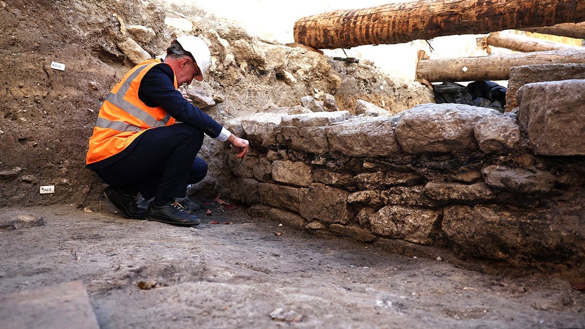 Archaeologist analyzing ancient wall in Paris
