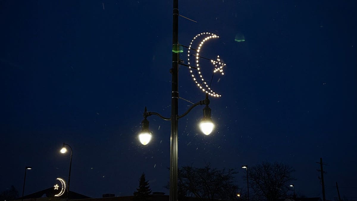 Illuminated crescent moons and stars hang from light poles in several Dearborn districts as part of the city’s celebration of Ramadan.