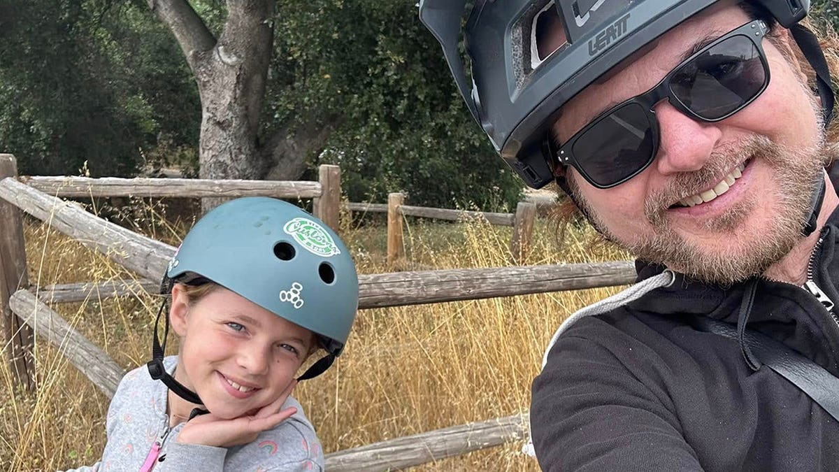 Rikki Rockett is seen here with his daughter in a selfie during a bike ride.