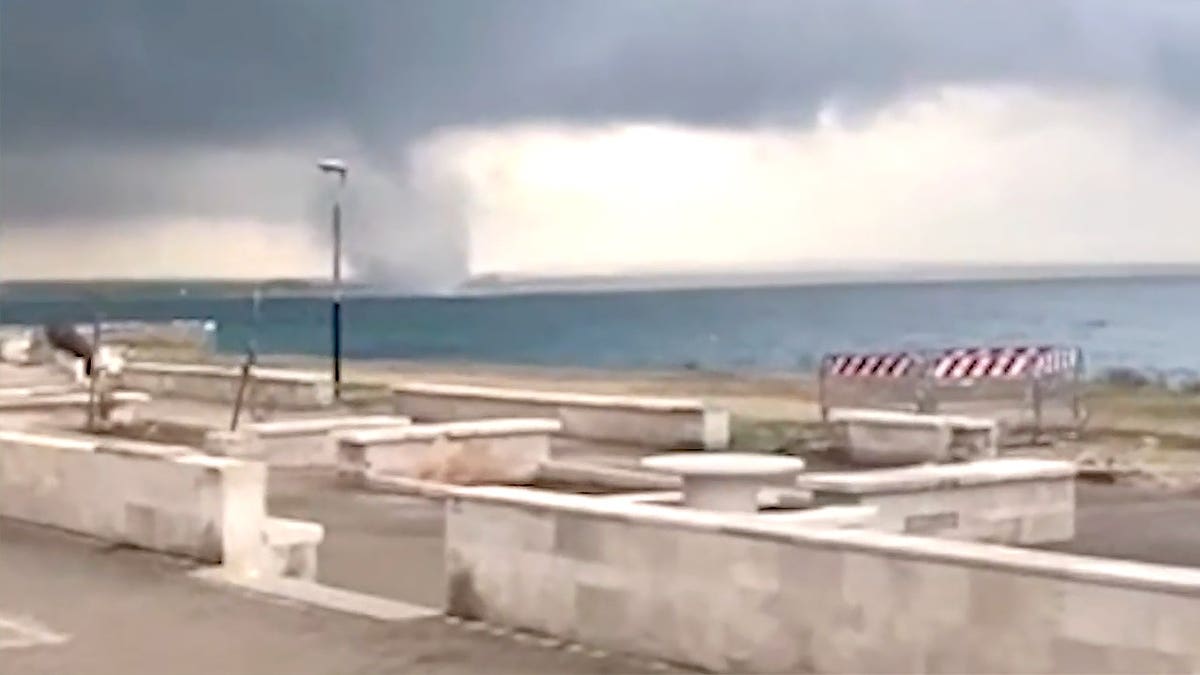 Wide view of tornado in distance from Sicilian town