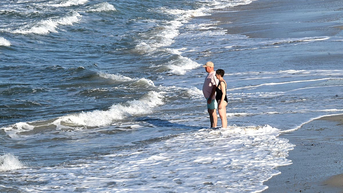 Tourists standing on beach in Djerba