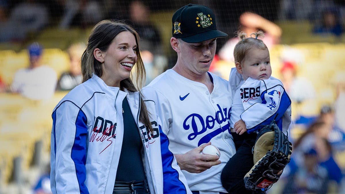 Will Smith stands with his wife Cara and daughter Charlotte at Dodger Stadium.