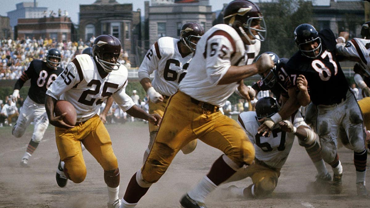 A.D. Whitfield carries the football during a game at Wrigley Field.