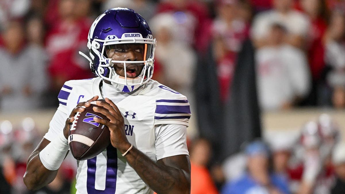 Aidan Chiles, Northwestern quarterback, looks to throw a pass against Indiana.