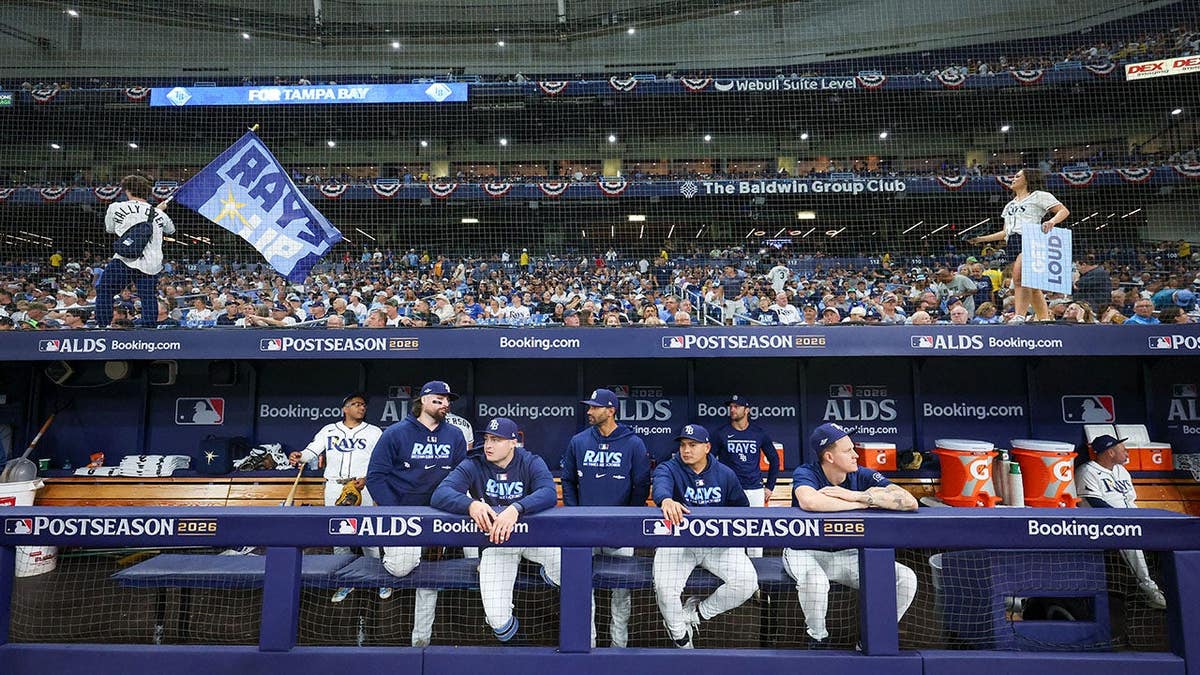 Tampa Bay Rays members look on from the dugout at Tropicana Field during the ALDS.