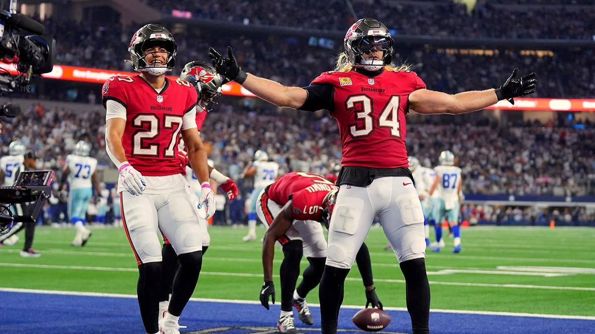Alex Anzalone celebrates after intercepting a pass in Arlington, Texas.