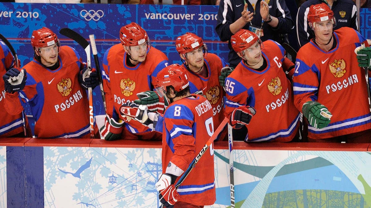 Alexander Ovechkin stands near the Russia bench during men's ice hockey preliminary action.