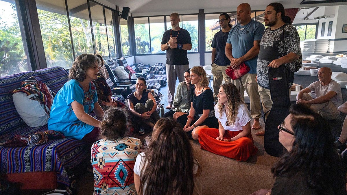 Female shaman Ananta speaks with medicine facilitators before an ayahuasca ceremony.