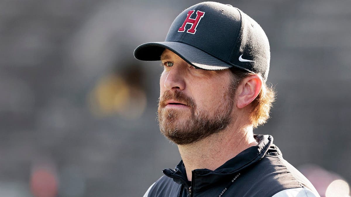Andrew Aurich oversees Harvard football practice at Harvard Stadium.