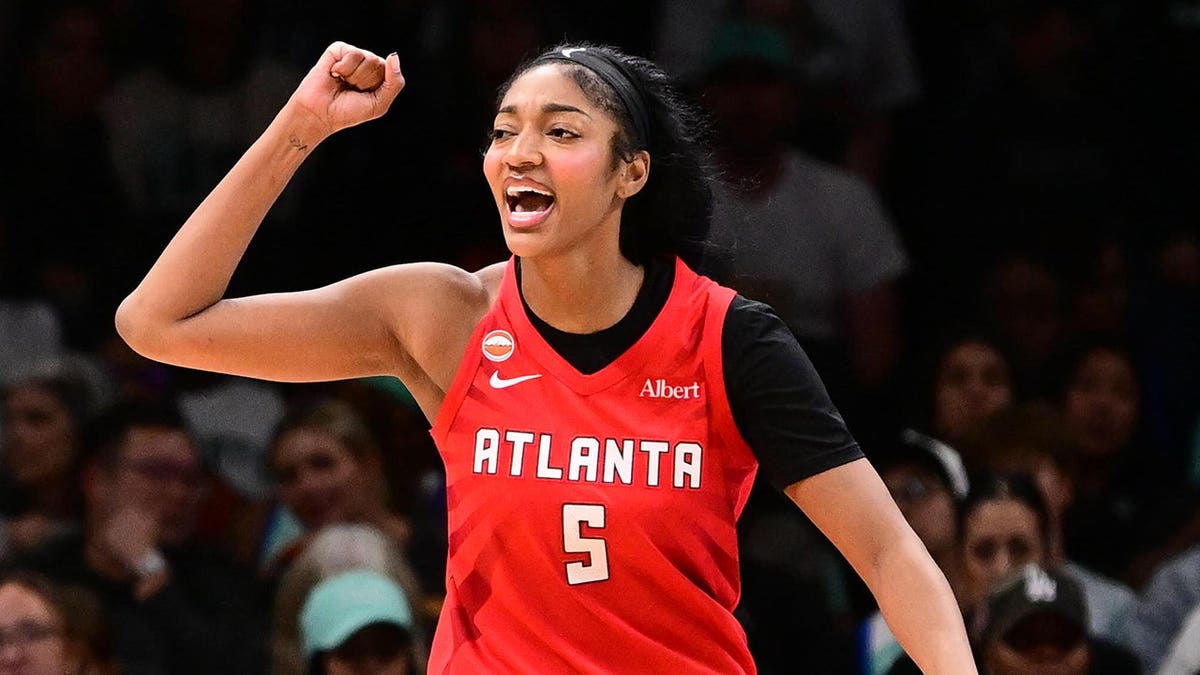 Angel Reese celebrates during a basketball game in Brooklyn.