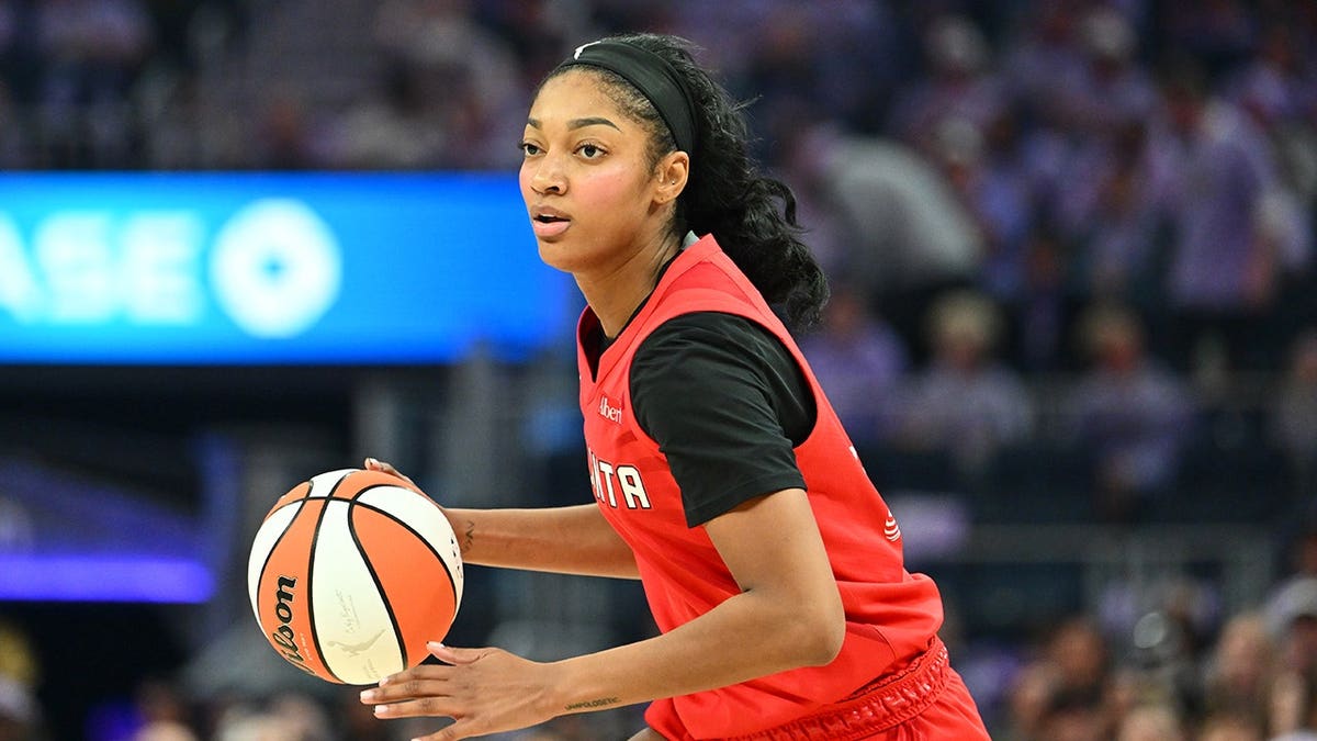 Angel Reese dribbles the ball during a WNBA Finals game at Chase Center.