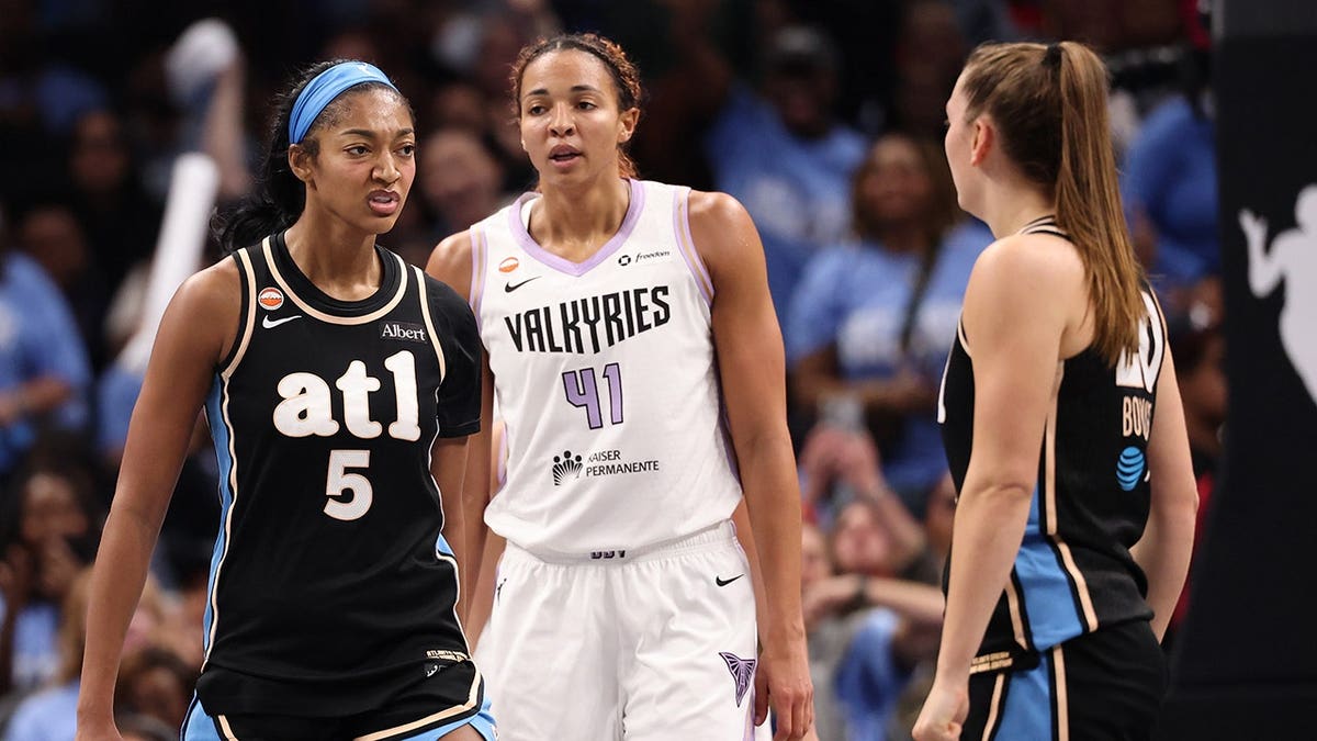 Angel Reese reacts with Isobel Borlase after scoring for the Atlanta Dream.