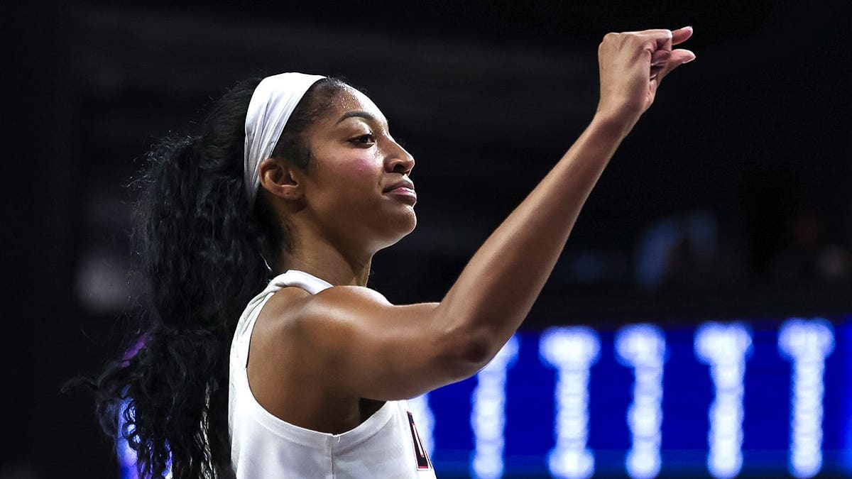 Angel Reese #5 gestures during a WNBA playoff game between the Atlanta Dream and Washington Mystics.