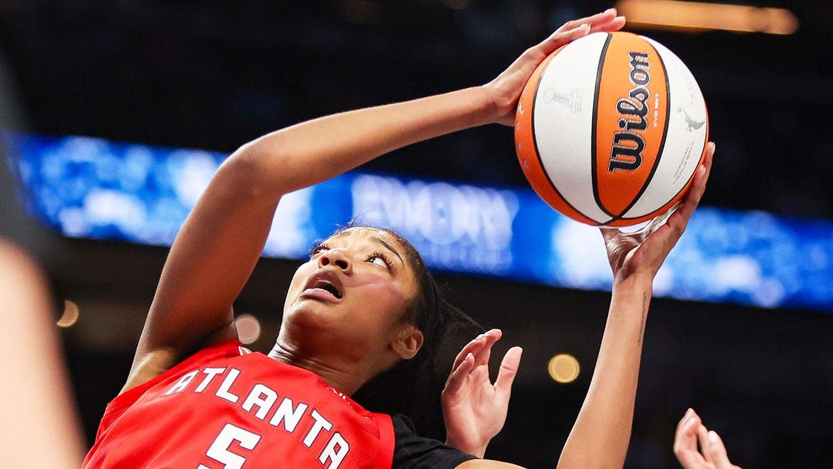 Angel Reese grabs a rebound against the Golden State Valkyries during the WNBA Finals.