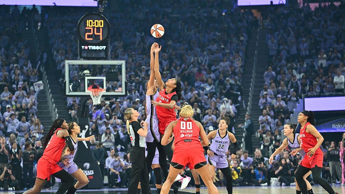 Angel Reese jumps for the opening tip against the Golden State Valkyries.