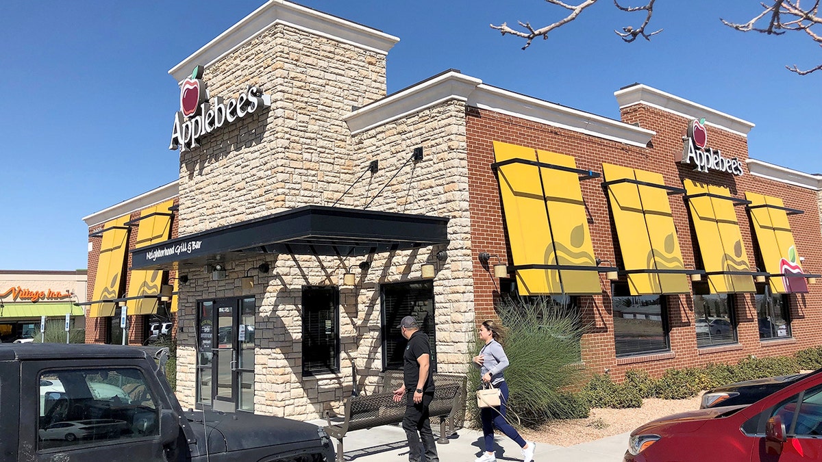 A man and woman enter an Applebee's in El Paso, Texas, in 2022.