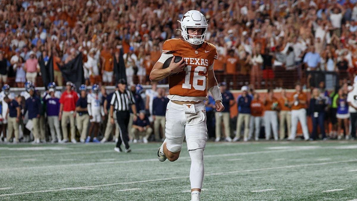 Arch Manning runs for a touchdown during a Texas Longhorns football game.