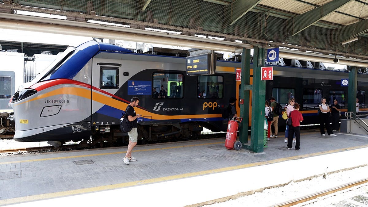 Trenitalia’s regional Pop train sits on the tracks at Bari station.