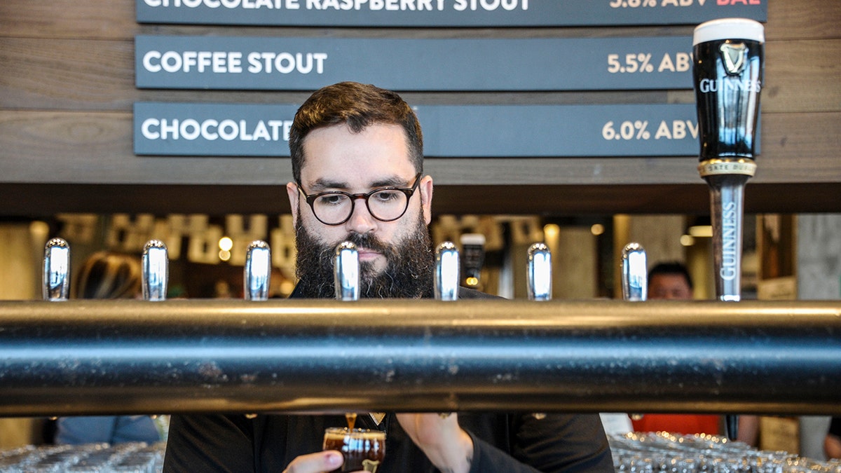 A bartender pours a beer at Guinness Open Gate Brewery in Maryland.