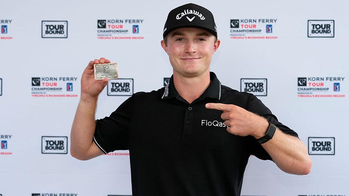 Blades Brown poses with his PGA Tour card