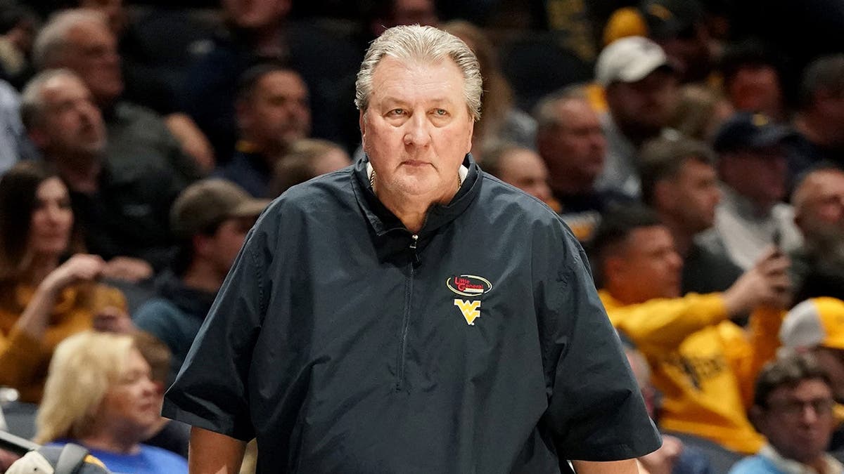 Bob Huggins, head coach of the West Virginia Mountaineers, looks on during a college basketball game.