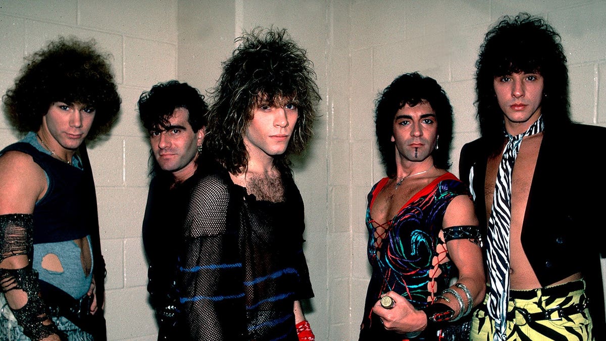 Bon Jovi band members pose backstage before a performance.