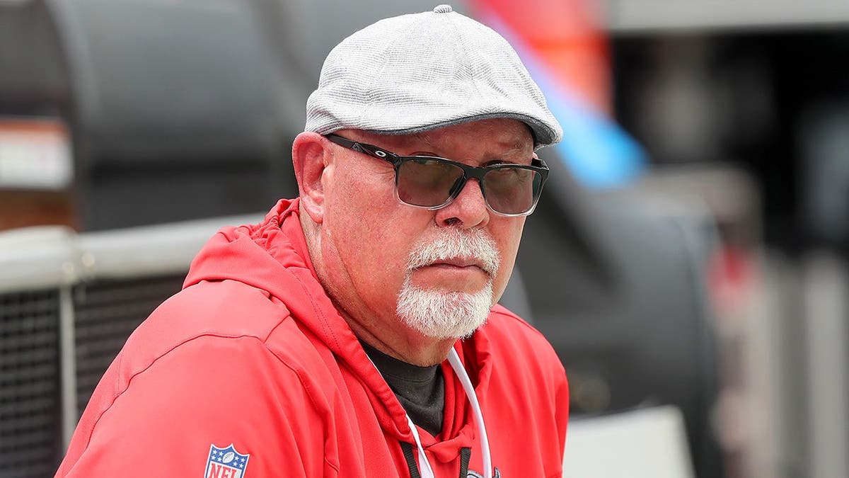 Bruce Arians sits along the sideline at Raymond James Stadium.