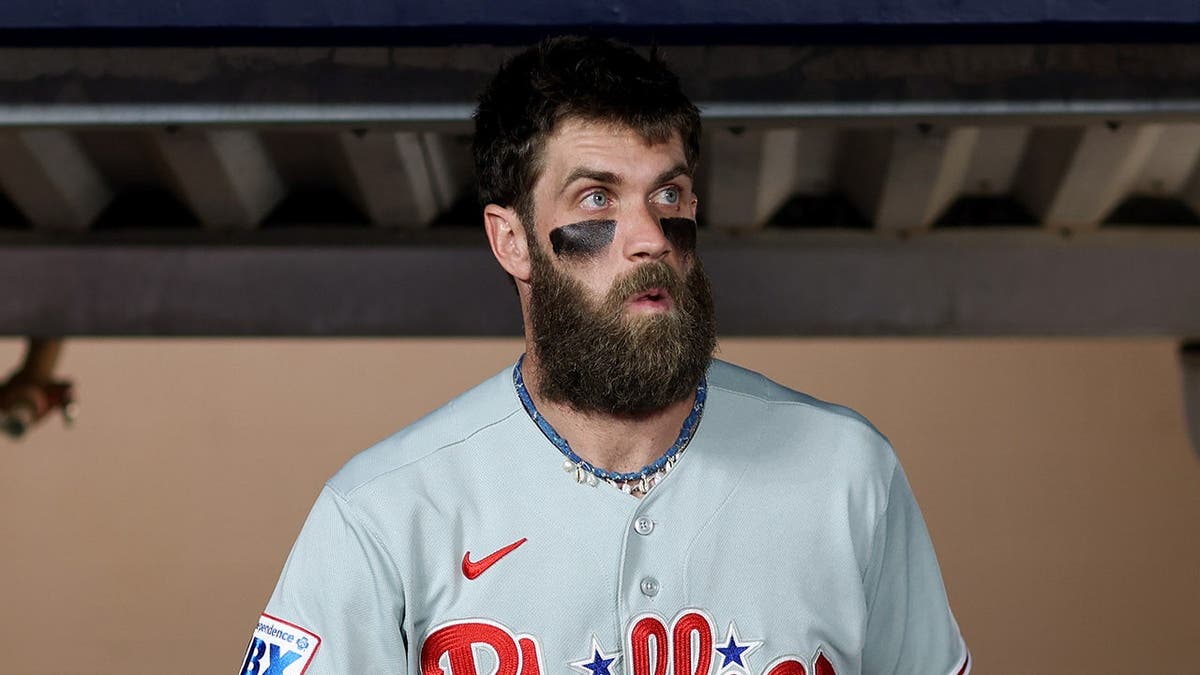 Bryce Harper enters the dugout at Truist Park.