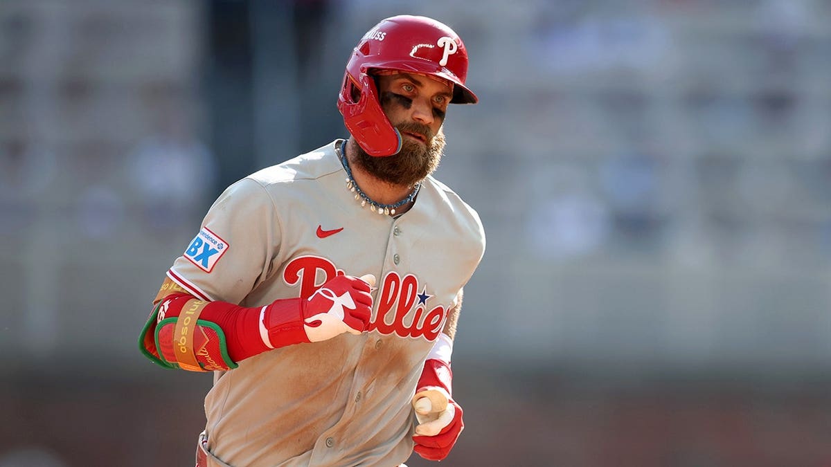 Bryce Harper rounds the bases after hitting a solo home run at Truist Park.