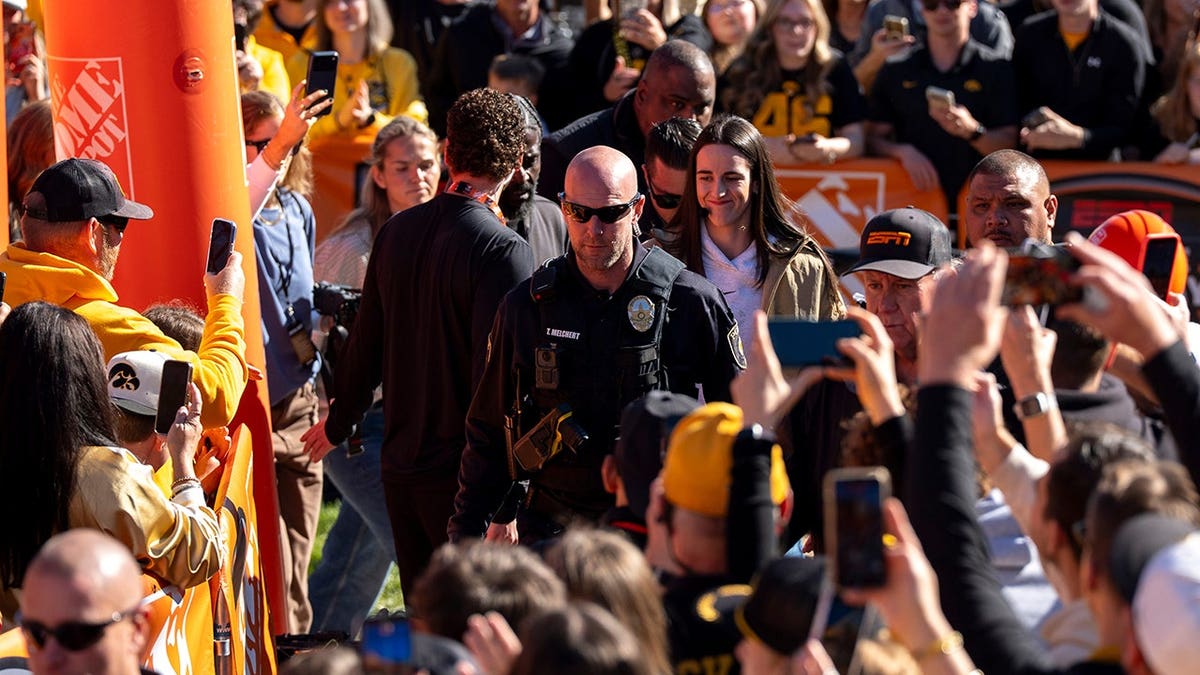 Caitlin Clark arrives at the ESPN College GameDay set in downtown Iowa City, Iowa.