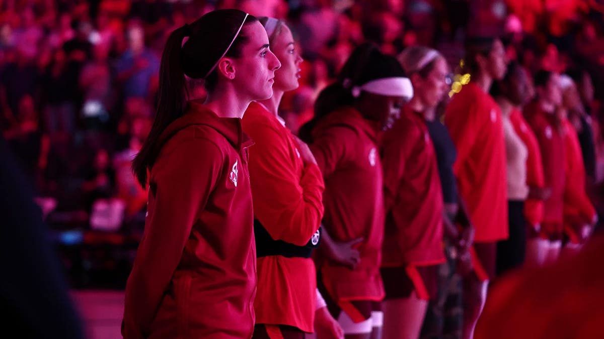 Caitlin Clark stands for the national anthem before a WNBA playoff game in Las Vegas.