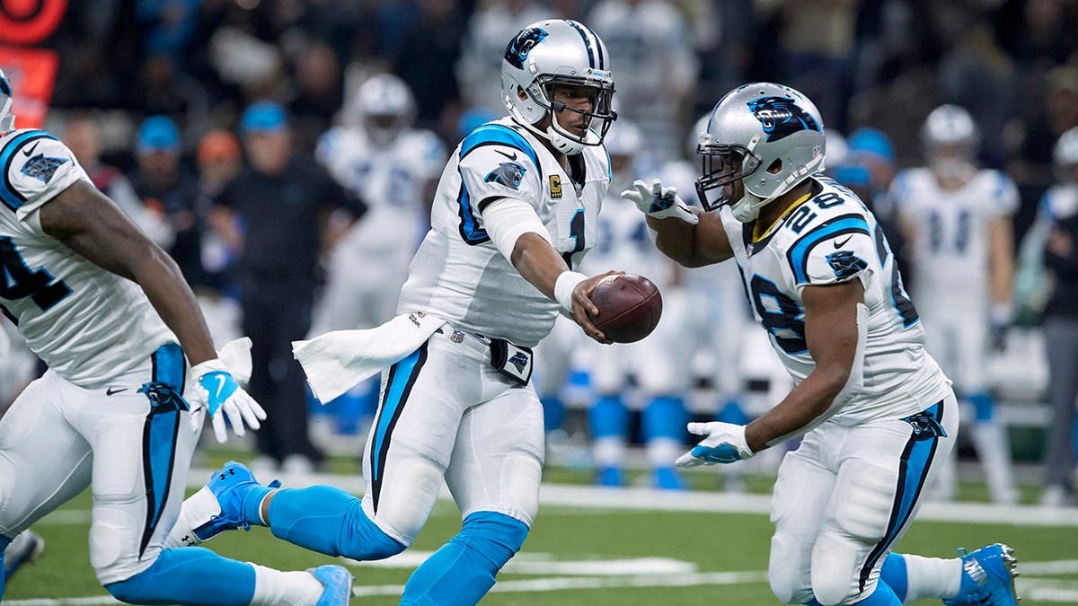 Cam Newton hands off to Jonathan Stewart during an NFC Playoffs game against the Saints.