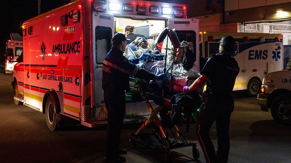 Paramedics load an injured person into an ambulance at Wainwright Health Centre.