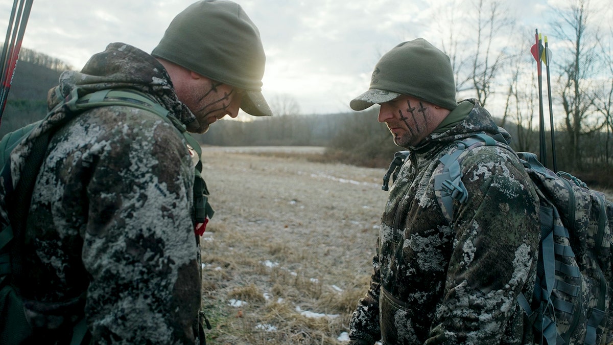 Chad and James Hampton praying outside.