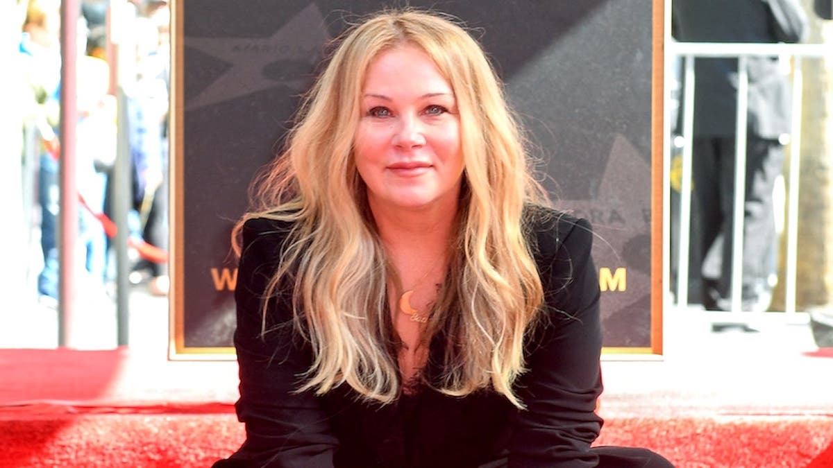 Christina Applegate poses with her Hollywood Walk of Fame star in Hollywood.