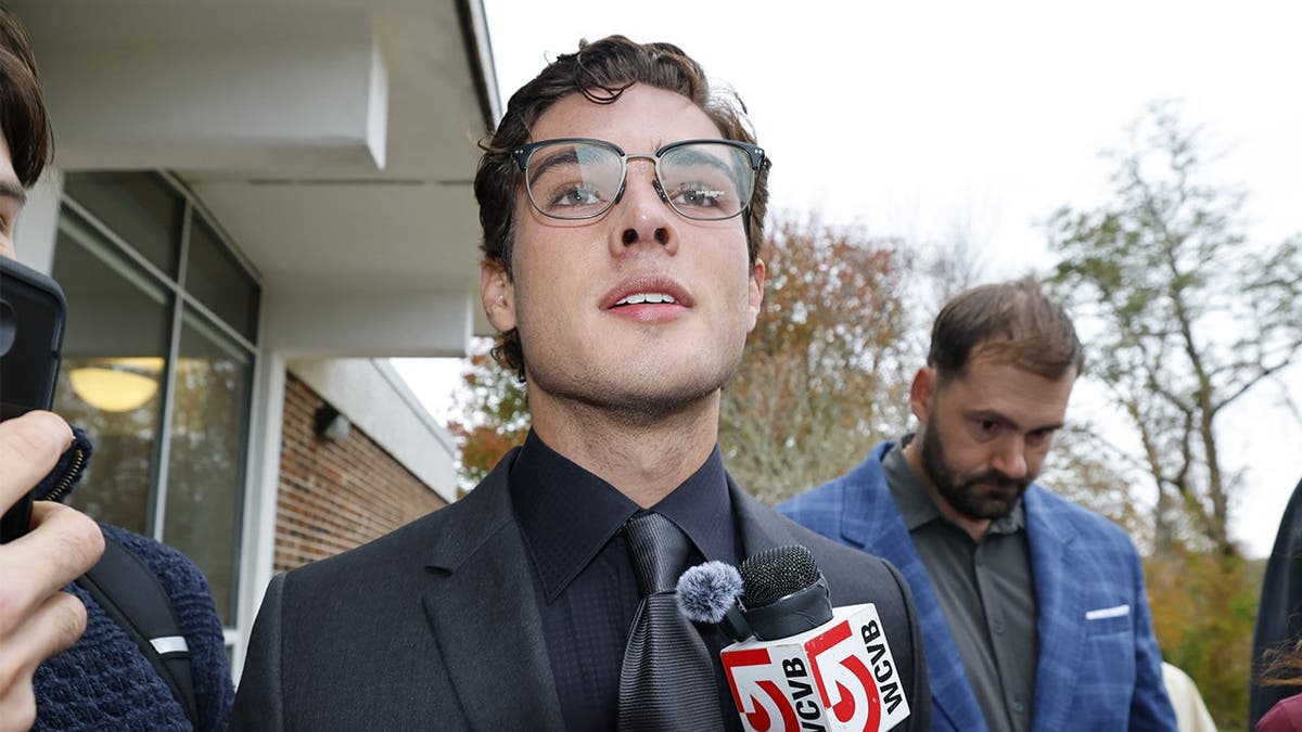 image shows defendant with microphone
