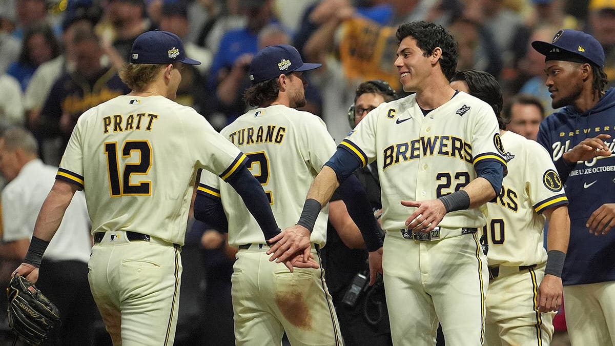 Cooper Pratt and Christian Yelich of the Milwaukee Brewers celebrate after defeating the Tampa Bay Rays.